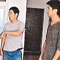 姚旋（左）與友人手持木棍在漢人小區巡邏。	（電視畫面）