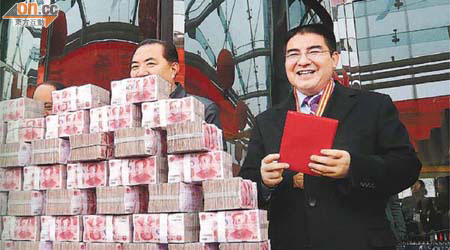 陳光標（右）在南京的捐贈活動展示巨幅「錢牆」。	（本報南京傳真）
