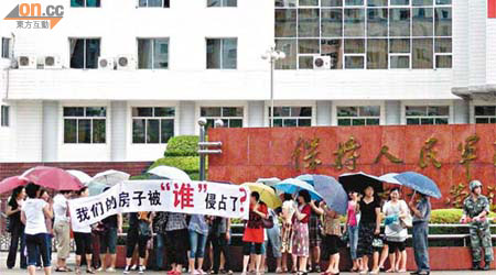 大批軍嫂於深圳營區外拉橫額抗議。