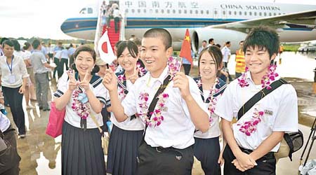 來自日本地震災區的學生，昨日抵達海口美蘭機場。	（中新社圖片）