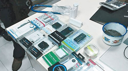 執法人員展示收繳的冒牌手機電池。（互聯網圖片）