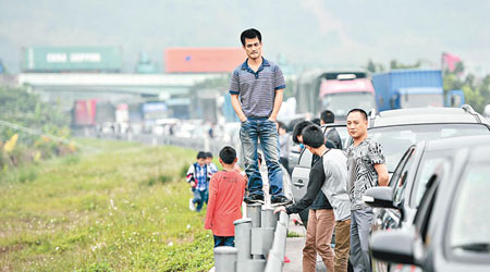 深汕高速因出現擠塞，大批民眾下車等候。　（中新社圖片）