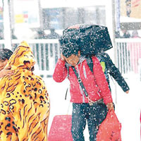 南昌火車站的旅客冒雪踏上歸途。（互聯網圖片）