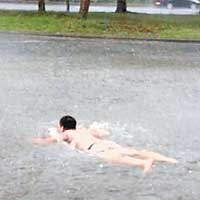 嘉義有男子在淹浸的馬路上暢泳。（互聯網圖片）