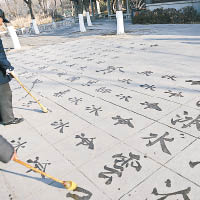濟南有老人冒寒在大明湖畔蘸水練書法。（中新社圖片）