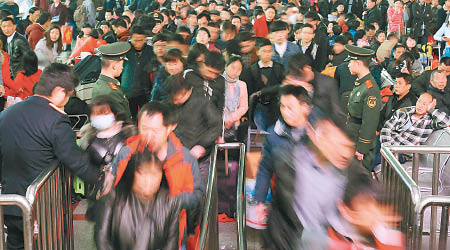 大批旅客在江西九江火車站排隊準備上車。（中新社圖片）