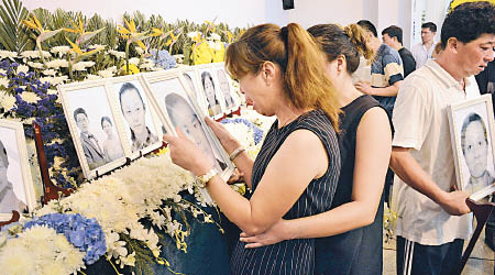 大連市死難者家屬和當地民眾悼念台灣旅巴慘劇的罹難者。（中新社圖片）