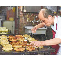 師傅阿大精心製作葱油餅。（互聯網圖片）