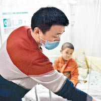 李洪留守在醫院照顧兒子。（互聯網圖片）