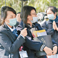 家屬到車禍現場拜祭時神情哀傷。（中新社圖片）