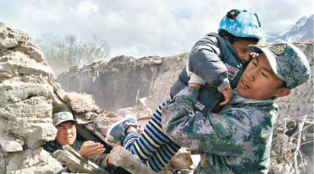 官兵在重災的庫孜滾村中發現一名受困男童。