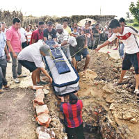 民眾安葬死難者。