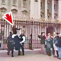 圖闖白金漢宮女子（箭嘴示）遭警員抬走。（互聯網圖片）