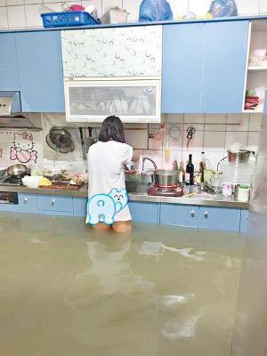 張婦雙腿泡水也要煮飯的一幕，感動網民。（互聯網圖片）