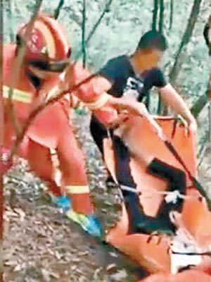 搜救人員用擔架把跳纜車的男子運走。（互聯網圖片）
