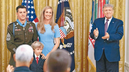 特朗普（右）向軍官佩恩（左一）授予榮譽勳章，表揚反恐貢獻。（美聯社圖片）