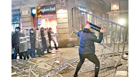 巴塞隆拿示威者反對封鎖措施，向防暴警員擲物。（美聯社圖片）