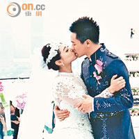 兩人切過結婚蛋糕後來個甜蜜擁吻。