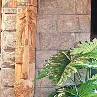 磚牆上掛上木刻雕飾，綴以綠葉盆栽，洋溢東南亞風情。