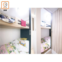 以木飾製作的睡房門，貫穿木製衣櫃，視覺效果更見統一；房間選用碌架床設計，更能善用空間。