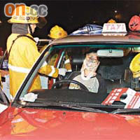 大埔公路金山水塘附近的士與私家車相撞，受傷的士司機由救護員急救。	（張曉楠攝）