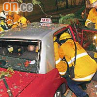 消防員將的士車門砸爛，救出被困司機。