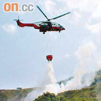 直升機向山火現場投擲水彈灌救。	（翁火攝）