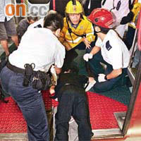 差錯腳婦人右腳插入月台與車廂間的空隙，身體趴落車廂地下，動彈不得。	（郭垂垂攝）
