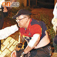 受傷的電單車司機，由救護員檢查傷勢。	（文健雄攝）