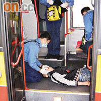 消防處救援人員將昏迷男子抬落巴士下層後，即進行檢查及急救。