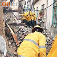 元朗洪水橋鍾屋村的荒廢石屋倒塌擊爆鄰居窗門，消防員在瓦礫堆中搜索。