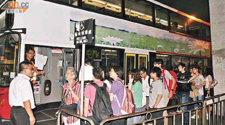 多名乘客在良景站附近輪候接駁巴士。	（余宏基攝）