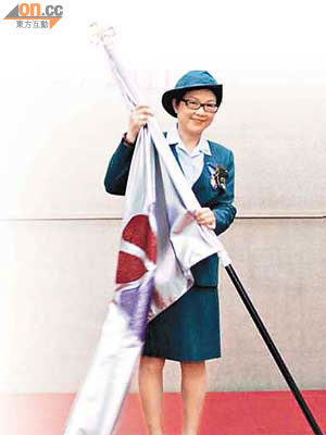 彭徐美雲接過總監旗，正式登上女童軍總會香港總監寶座。	（女童軍提供）