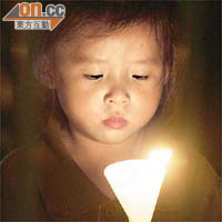 小童手持燭光哀悼六四死難者。