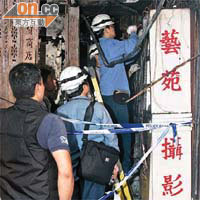 中電職員在起火唐樓檢查電箱。	（陳錦昌攝）
