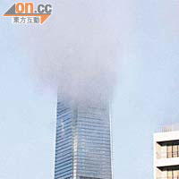雲霧罩着環球貿易廣場高層，被誤會着火湧出濃煙。	（楊偉嶽攝）