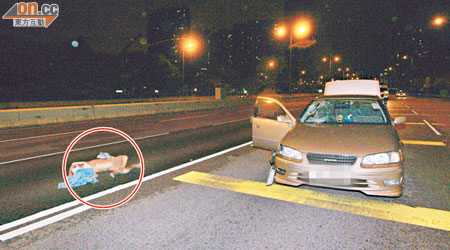 男子陳林走過公路被私家車狂撞扯甩褲，半裸伏屍路中（圓圈示）。（邱國賢攝）