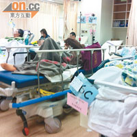 診室逼爆<br>診療室擠滿等候上房的病人，床位緊貼，空氣悶焗。