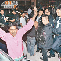 元朗<BR>被捕南亞漢的同鄉高舉雙手，讓記者拍照。