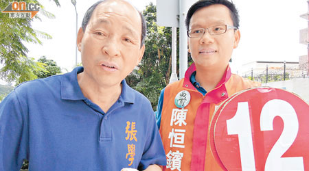 張學明（左）落荃灣圍村幫支持度唔高嘅陳恒鑌（右）拉票。（鄧湄攝）