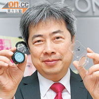 消委會宣傳及社區關係小組副主席梁光漢手持含鉛超標的「VOV」（左）及含菌過量的「Beauty Tech」（右）。