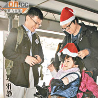 獲選為本年度香港精神大使的鄧嘉玲（坐輪椅者）與衡仔（右）在平安夜早上傳播歡樂訊息。