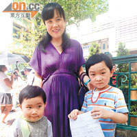 從深圳移居本港的庄太說很開心兒子（右一）獲派第一志願小學。（羅錦鴻攝）