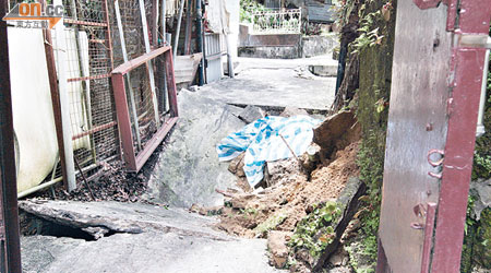 發生下陷的村路，旁邊亦有山泥坍塌。（譚珮蓮攝）