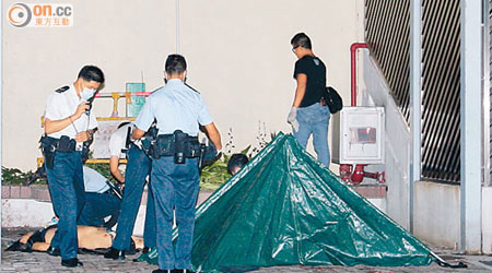 警員用帆布將墮樓男子屍體遮蓋調查。（張曉楠攝）