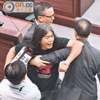 立法會議員梁國雄（中）衝向陳茂波，指其可恥，遭保安人員阻擋。