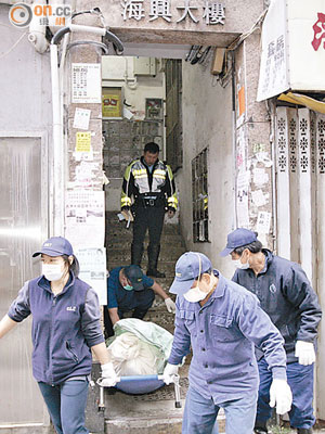 吊頸男子遺體由仵工舁送殮房。（夏國威攝）