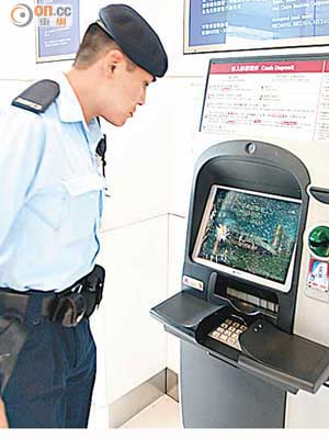 警員在上海商業銀行被扑毀櫃員機現場調查。（林明強攝）