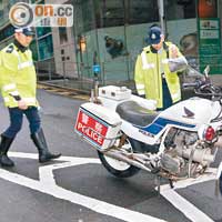 警員檢視涉事的電單車。（張曉楠攝）