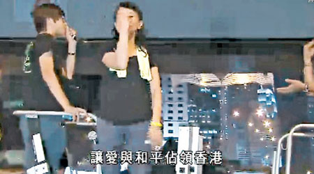 佔中工作人員做錯代表「香港」嘅手語，動作由打開手指變收緊手指，意思變咗「麵包」。（電視畫面）